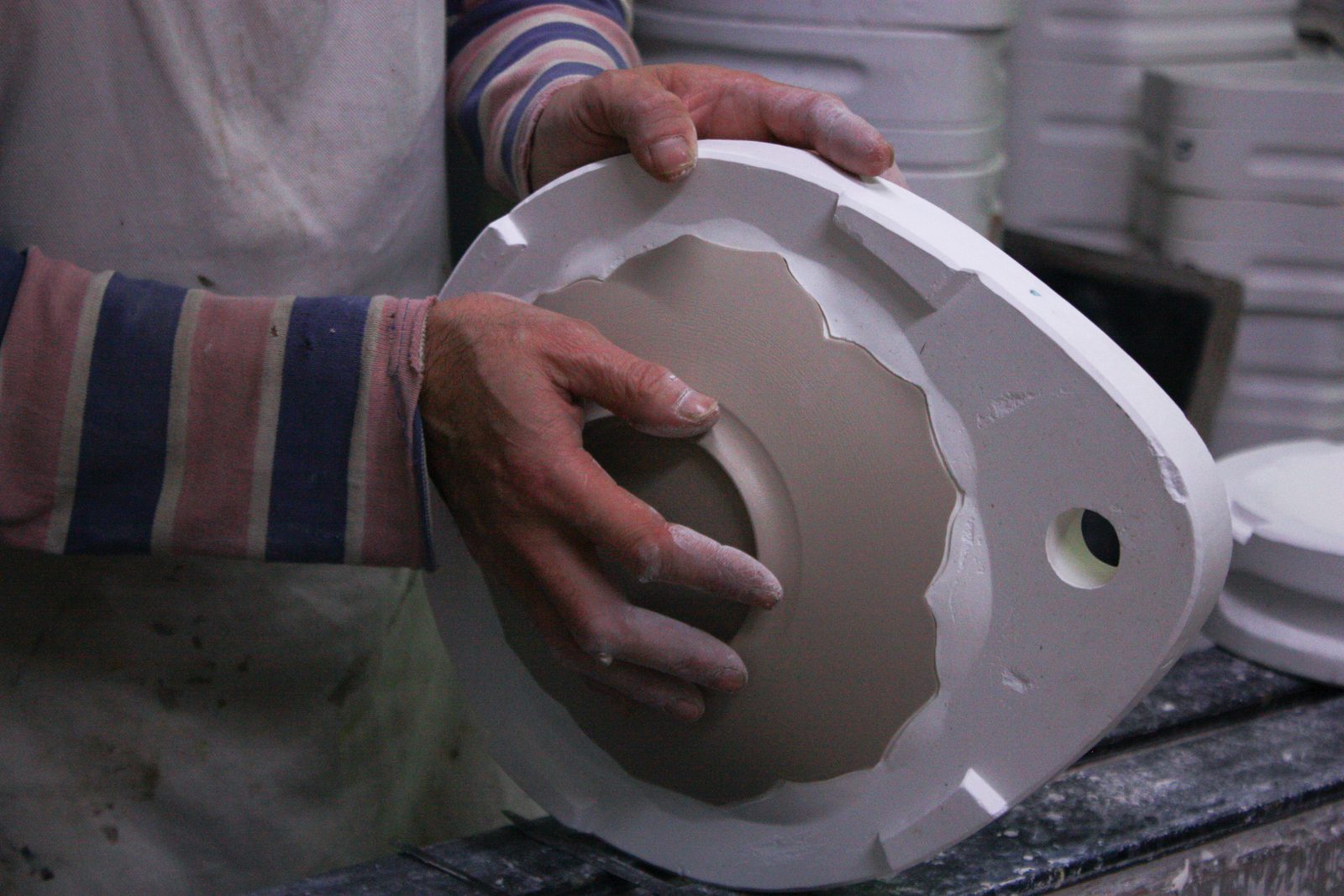 Hands holding a plaster mould