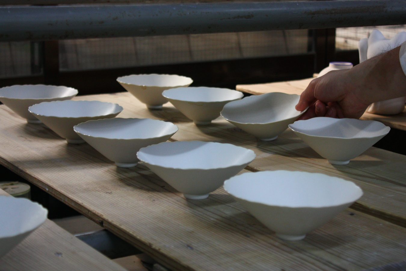 Bowls being set out by hand in the Touan workshop, Kyoto